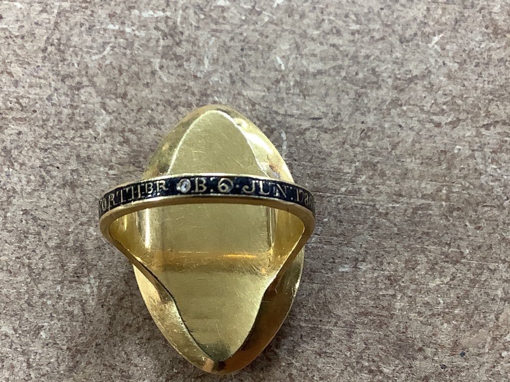A George III yellow metal and three colour enamel navette shaped mourning ring, with Ducal coronet above 'N' on a pedestal with urn above, the shank with black enamel inscription which reads 'HU. DUX NORTHbr. OB 6 Jun. 1